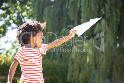 Boy is playing with a paper plane