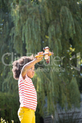 Boy is playing with a toy plane