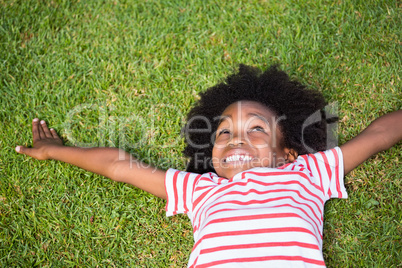 Smiling boy lying down in grass
