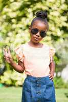 Little girl with sunglasses at park