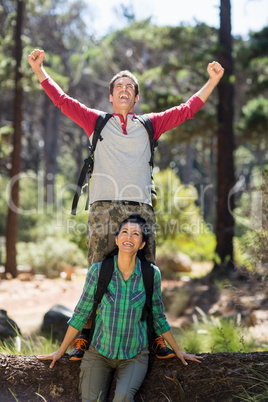 Couple smiling and throwing up arms