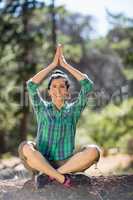 Woman smiling and doing yoga