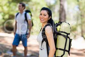 Woman smiling and posing with a backpack