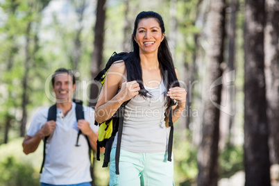 Couple smiling and posing with their backpack