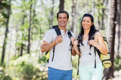 Couple smiling and posing with their backpack