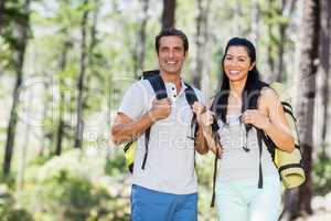 Couple smiling and posing with their backpack