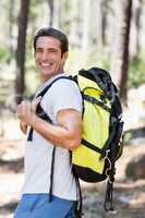 Man smiling and posing with his backpack