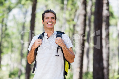 Man smiling and posing with his backpack