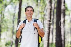 Man smiling and posing with his backpack