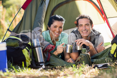 Couple laying and holding cup