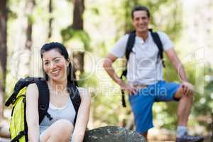 Couple smiling and posing with their backpack