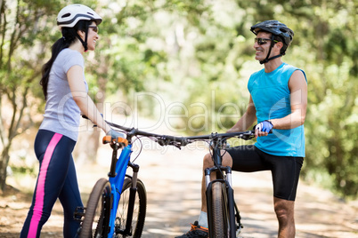 Couple posing with their bikes