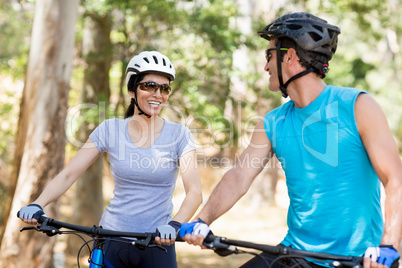 Couple looking each other with their bikes