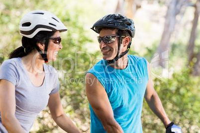 Couple looking each other with their bikes