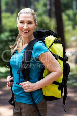 Woman smiling and posing with a backpack