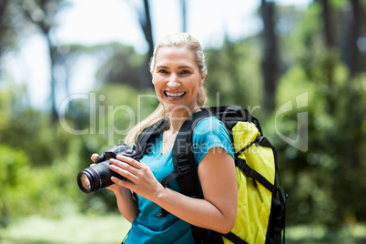 Woman smiling and posing with her camera