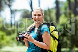 Woman smiling and posing with her camera