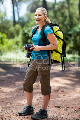 Woman smiling and holding a camera