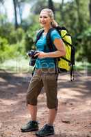 Woman smiling and holding a camera