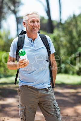 Man smiling and holding a flask