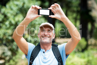 Man smiling and taking a photo