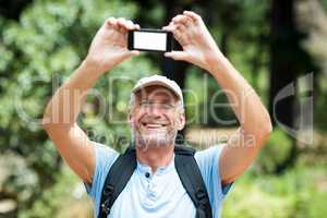 Man smiling and taking a photo