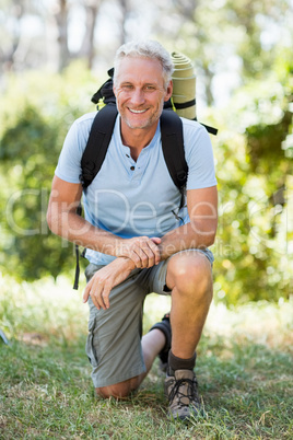 Man smiling and squatting