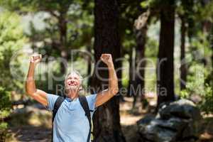 Hiker smiling and throwing arms