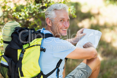 Hiker smiling and holding a map