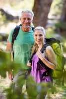 Couple smiling and posing during a hike