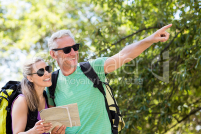 Couple pointing and holding a map