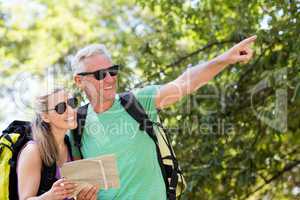 Couple pointing and holding a map