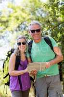 Couple smiling and holding a map