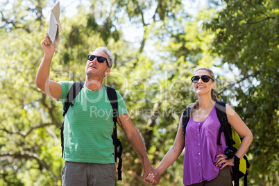 Couple pointing and holding hands during a hike