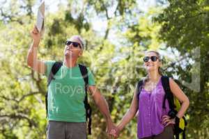 Couple pointing and holding hands during a hike