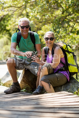 Couple smiling and taking a break during a hike