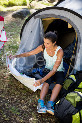 Woman sitting and studying a map