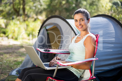 Woman smiling and using a computer