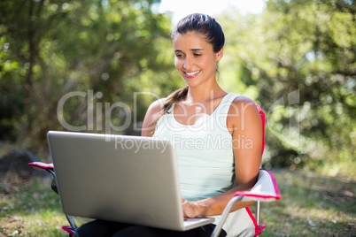 Woman smiling and using a laptop