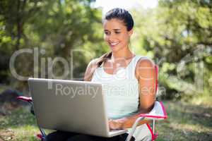 Woman smiling and using a laptop