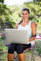 Woman smiling and using a laptop