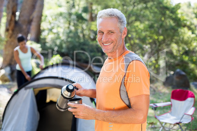 Man smiling and taking some drink