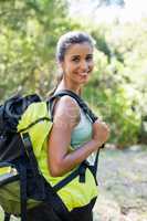 Woman smiling and posing with her backpack