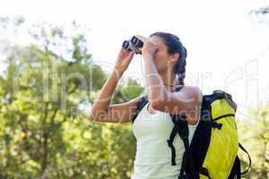 Woman looking something with binoculars