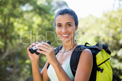Woman smiling and holding binoculars