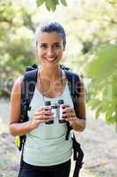 Woman smiling and holding binoculars