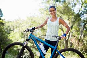 Woman smiling and posing with her bike