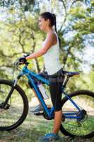 Woman smiling and posing with her bike