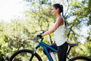 Woman smiling and posing with her bike