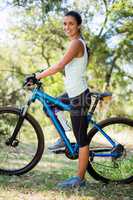 Woman smiling and posing with her bike